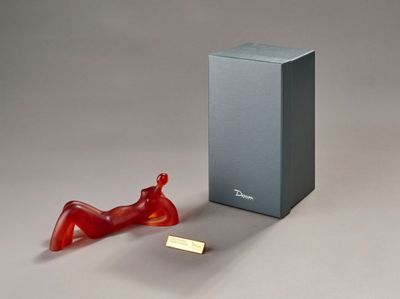 a red object sitting next to a box on a table