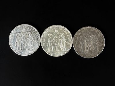 three silver coins, one of which is a sovereign and one of which is a sovereign