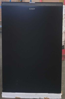 a black refrigerator that is sitting in the middle of a room