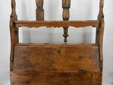 an old wooden magazine rack with two candles on top of it