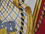 a close up of a yellow and blue tie with a crest on it