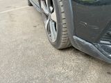 a close up of a car ' s front bumper and tire