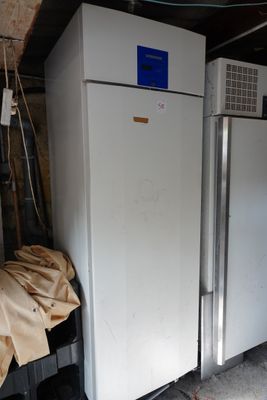 two refrigerators that are in a garage next to each other
