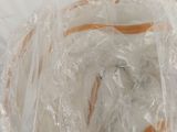 a bag of bread wrapped in plastic on a table