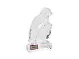 a clear glass bird on a clear base with a red plaque