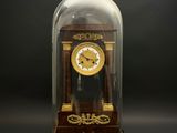 a clock under a glass dome on a black background