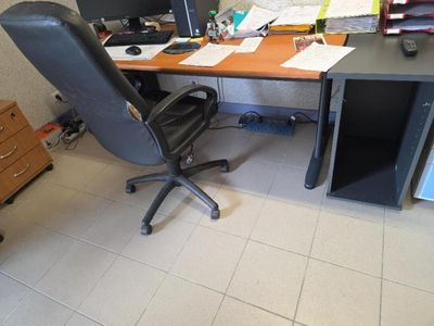 a desk with a chair and a computer on it