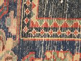 a close up of a rug with a blue background and a red border