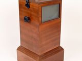 a small wooden box with a glass window in it