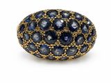 un gros plan d'une bague sertie de saphirs bleus sur fond blanc