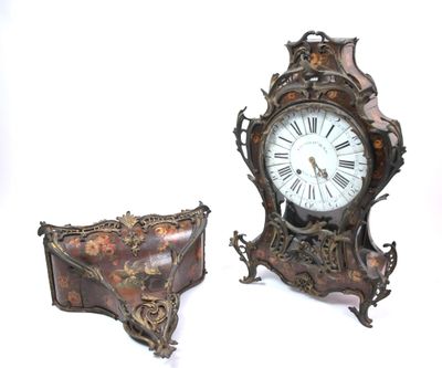 two clocks that are sitting next to each other on a table