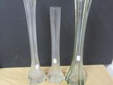 three vases sitting on a table next to each other