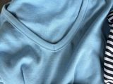 several shirts stacked on top of each other on a table
