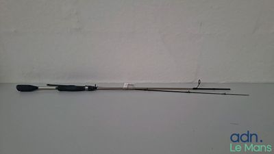 a close up of a fishing rod on a table near a wall