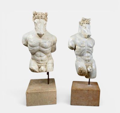 deux statues représentant un homme et une femme, posées sur un socle en bois