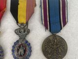 three medals and a medal on a white surface