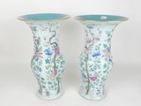 pair of chinese vases with birds and flowers painted on them