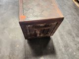 a wooden box with a drawer on top of it on the floor