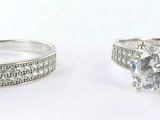 pair of engagement rings with diamonds on them on a white background
