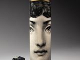 a picture of a lamp with a picture of a woman ' s face on it