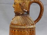 a brown pitcher that is sitting on a table