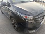 the black van is parked in the parking lot near other cars
