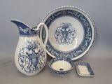 a blue and white pitcher and a plate with a spoon
