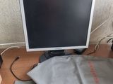 a laptop computer sitting on a desk with a bag on top of it