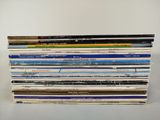 a lot of books that are stacked on top of each other