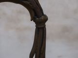 a close up of a wooden chair with a metal handle