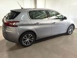 the back of a silver car in a garage