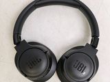 a pair of black headphones sitting on top of a table