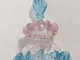 a glass vase with a fish on top of it