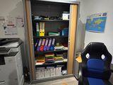 a desk with a chair and a printer in a room