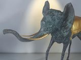 a statue of an elephant that is standing on a table