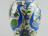 a blue and white vase with birds and flowers on it