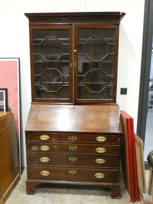 a wooden desk with a glass door and drawers