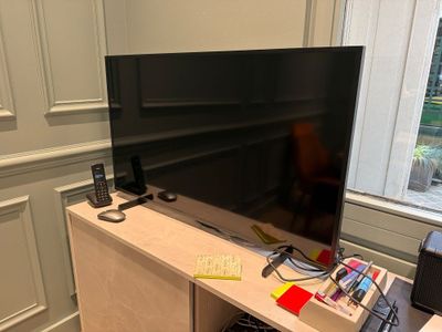 a flat screen tv sitting on top of a wooden cabinet