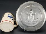 two cups and a plate with a picture on them