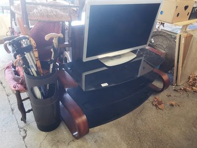 a computer monitor sitting on top of a desk next to a chair