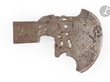 an old axe with a carved handle on a white surface