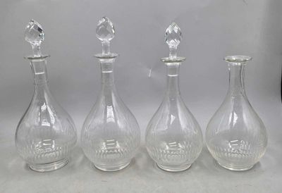 trois carafes en verre transparent surmontées d'un oiseau