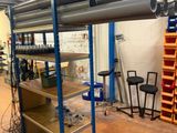a room with shelves and shelves with pipes on them