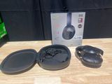 the headphones are sitting on the table next to the box