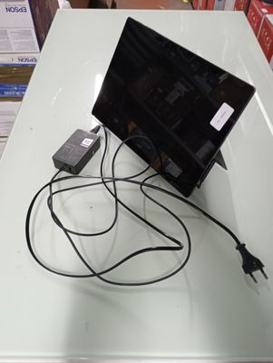 a laptop computer sitting on top of a white table
