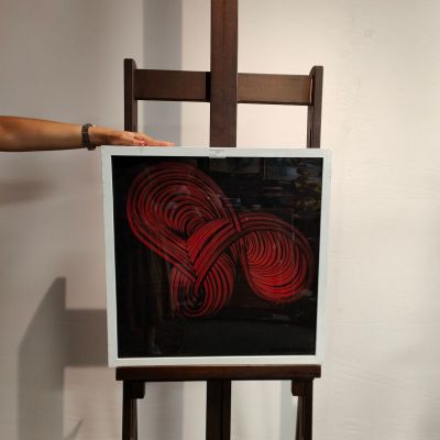 a person standing next to a painting on a easel