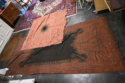 two rugs that are on the floor in a room