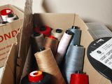 many spools of thread and spools in a box