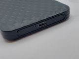 a black cell phone sitting on a table next to a box of tissues