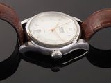 a close up of a wrist watch with a brown leather band